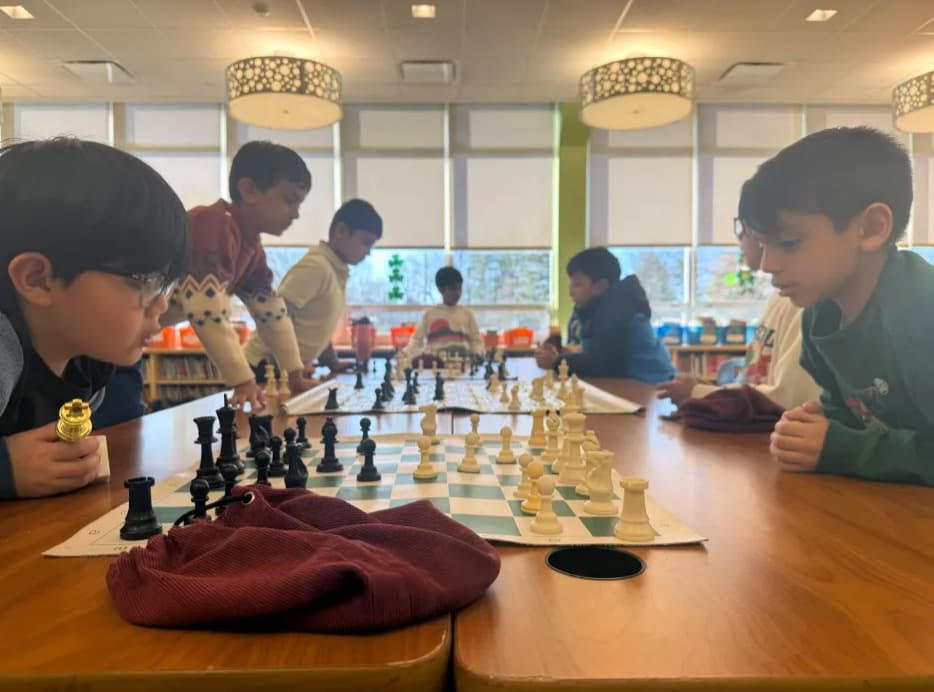 Students learning chess in an engaging classroom workshop