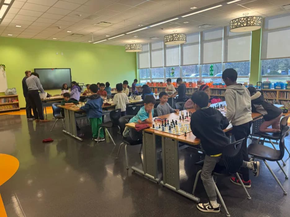 Students learning chess in classroom